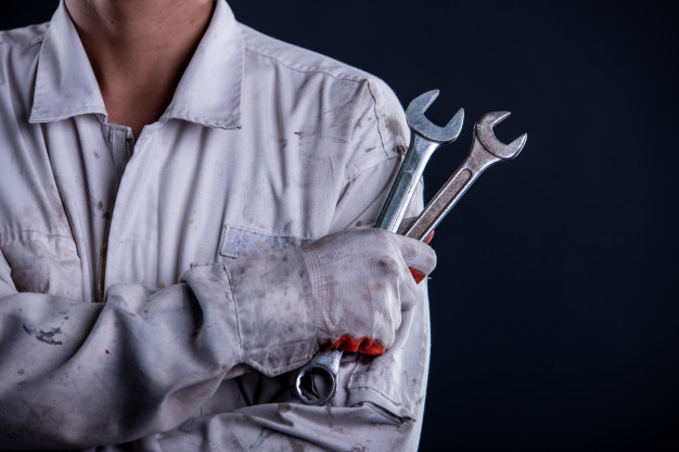 car-mechanic-wearing-white-uniform-stand-holding-wrench_1150-16608